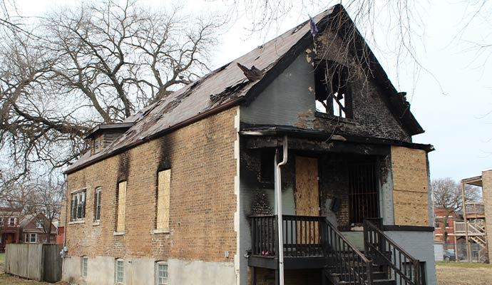 Boarded up fire damaged house