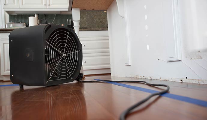 Industrial air mover fan drying a hardwood floor Industrial air mover fan drying a hardwood floor