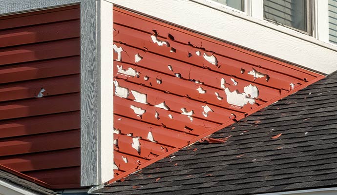 Home exterior siding with visible hail damage