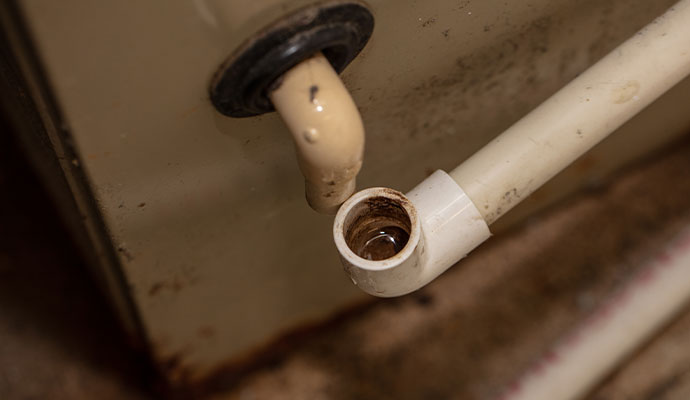 HVAC condensate drain line dripping into pipe