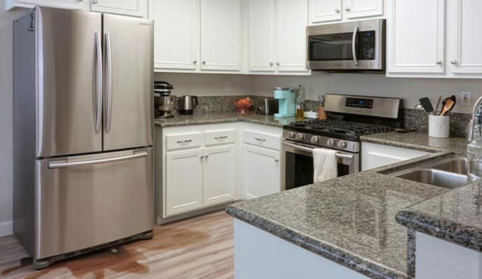 Leaking refrigerator in modern kitchen
