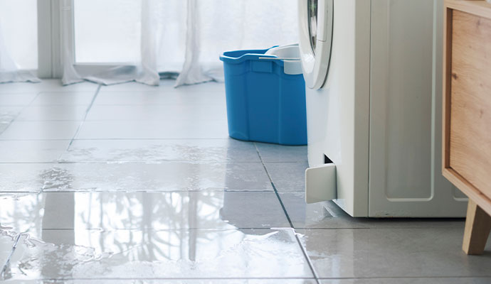 Leaking washing machine on flooded floor
