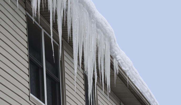 Snow piling up on the roof of a house