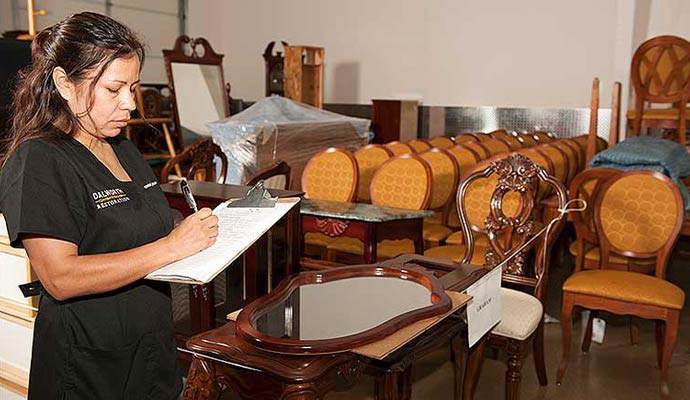 Expert making a list of restored items