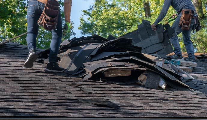 Roof damage restoration service by technician