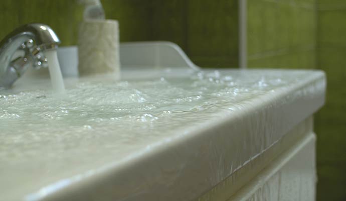 Bathroom sink overflowing water