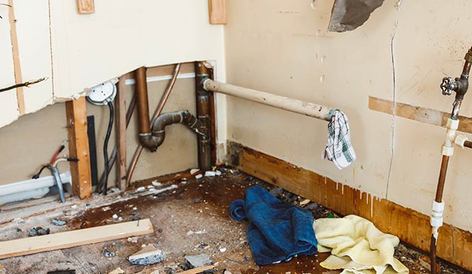 Debris and structural damage after a main water line break.