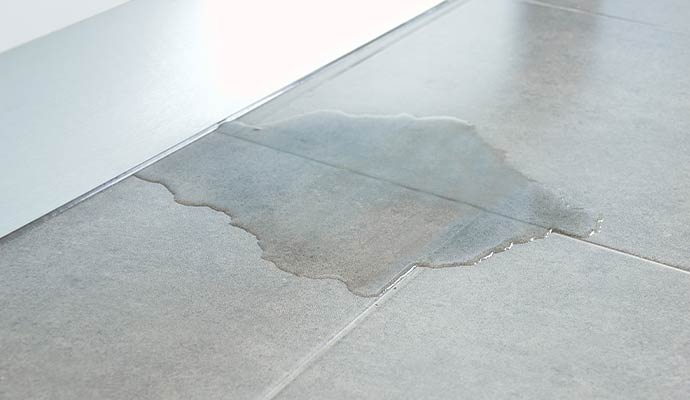 Leaking water on tile floor