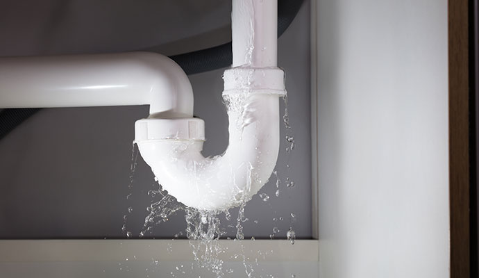 Water leaking from damaged pipe